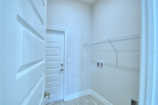 laundry room featuring hookup for a washing machine and light hardwood / wood-style floors