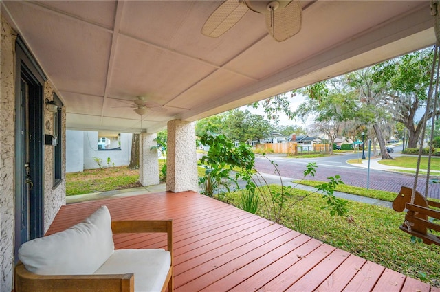 wooden deck featuring ceiling fan and a porch