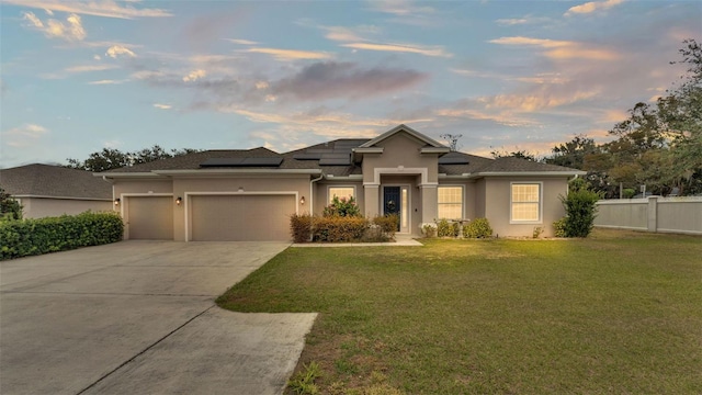 view of front of home with a lawn and a garage