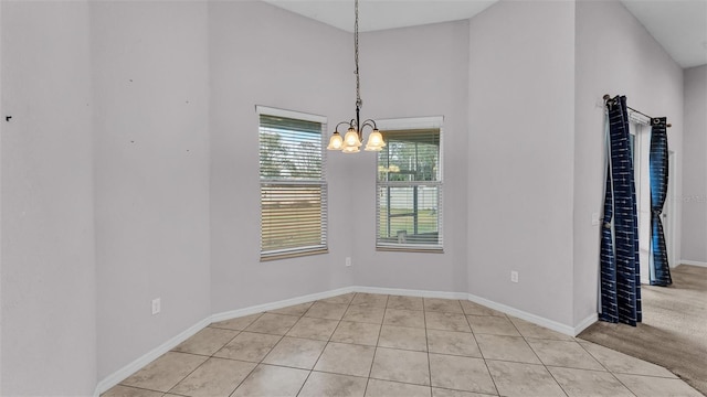 unfurnished dining area with light tile patterned floors and a notable chandelier