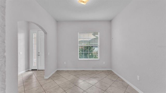 spare room featuring light tile patterned floors