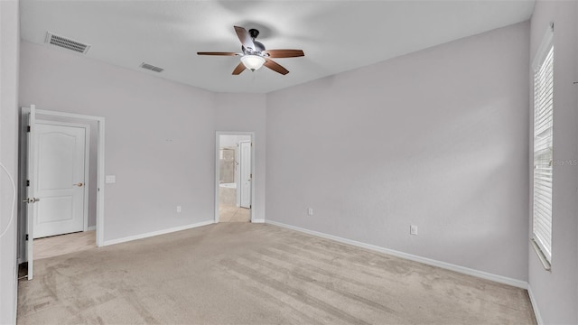 carpeted spare room featuring ceiling fan