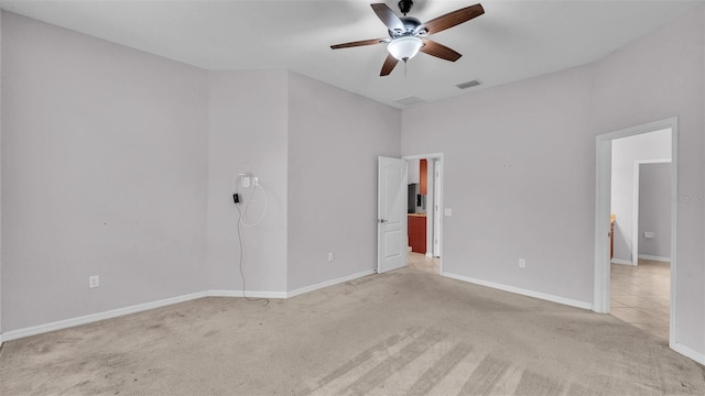 carpeted empty room featuring ceiling fan