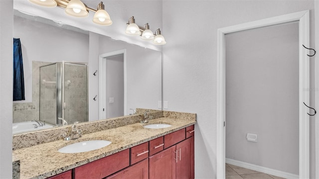 bathroom with tile patterned floors, vanity, and shower with separate bathtub