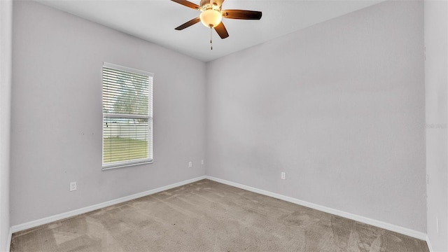 spare room featuring light carpet and ceiling fan