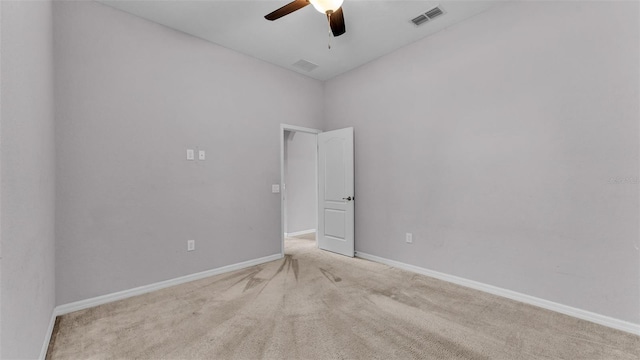 carpeted spare room featuring ceiling fan