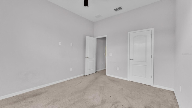 unfurnished bedroom featuring ceiling fan and light colored carpet