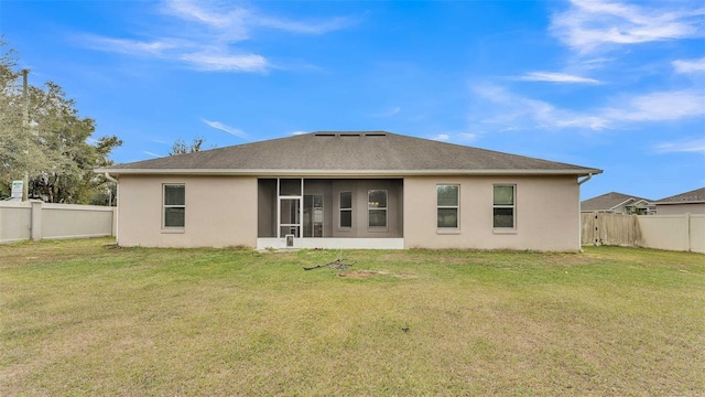 rear view of property with a lawn