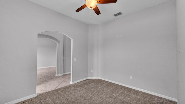 212 Kissengen Park Dr, Bartow, FL 33830 - carpeted spare room featuring arched walkways, ceiling fan, baseboards, and tile patterned floors