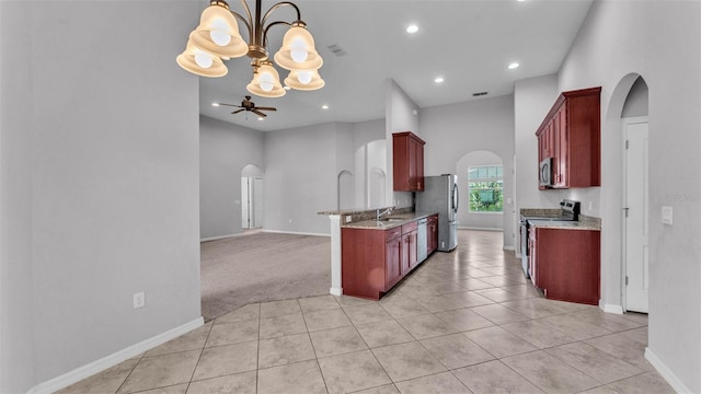 212 Kissengen Park Dr, Bartow, FL 33830 - kitchen with appliances with stainless steel finishes, arched walkways, reddish brown cabinets, and recessed lighting