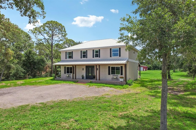 view of front of property featuring covered porch and a front yard