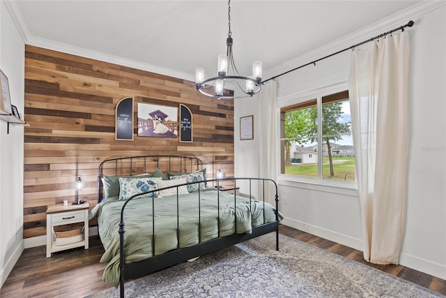 bedroom with dark hardwood / wood-style flooring, ornamental molding, wood walls, and a chandelier