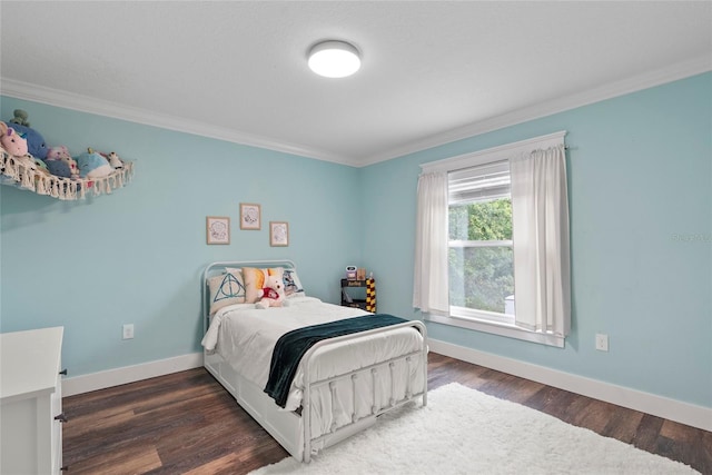 bedroom featuring ornamental molding and dark hardwood / wood-style flooring