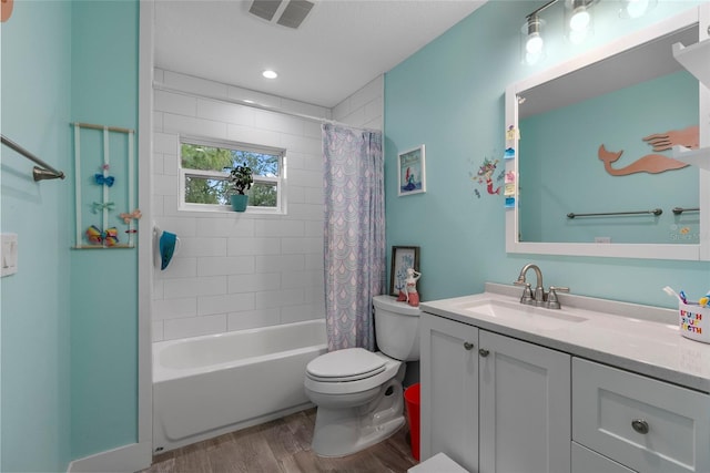 full bathroom with toilet, vanity, wood-type flooring, and shower / bath combo with shower curtain