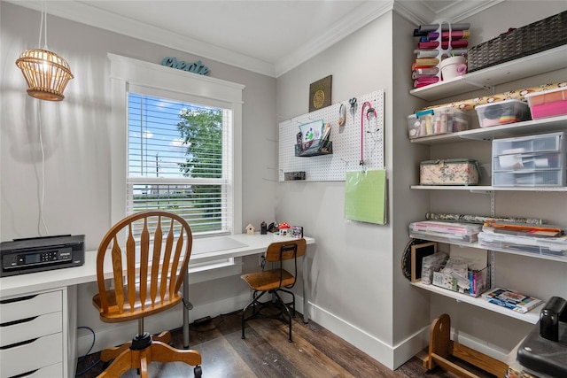 office space featuring built in desk, dark wood-type flooring, and ornamental molding