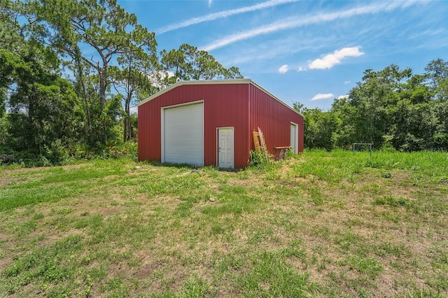 view of outbuilding with a garage and a yard