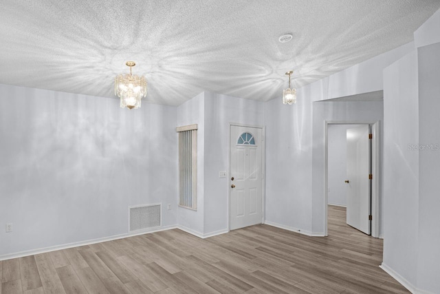 interior space featuring a chandelier and light hardwood / wood-style floors