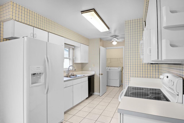 kitchen featuring light tile patterned flooring, white cabinetry, separate washer and dryer, sink, and white appliances