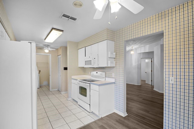 kitchen with white cabinetry, white appliances, ceiling fan, and light tile patterned flooring