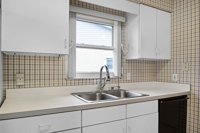 kitchen with sink, a wealth of natural light, dishwasher, and white cabinets