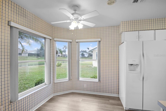 interior space featuring ceiling fan and plenty of natural light