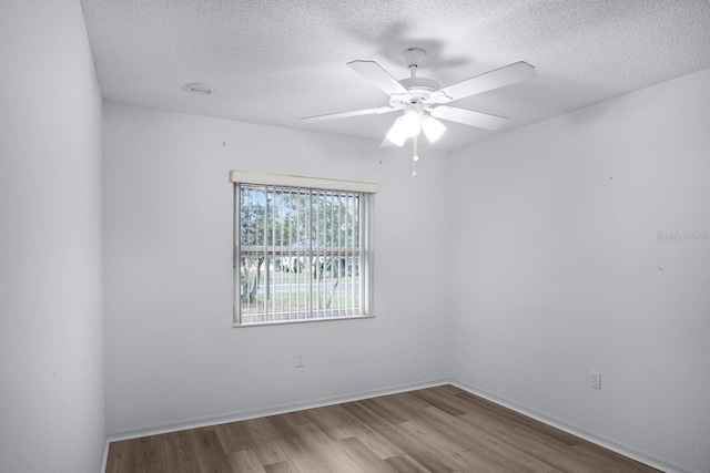 unfurnished room with ceiling fan, a textured ceiling, and light hardwood / wood-style flooring