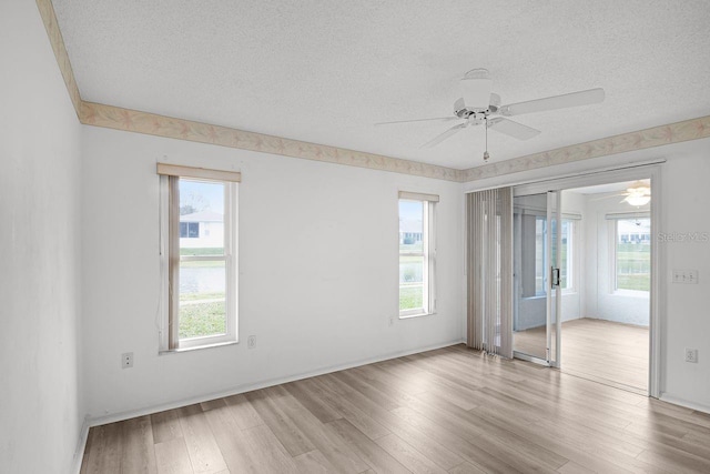 unfurnished room featuring ceiling fan, a textured ceiling, and light hardwood / wood-style flooring