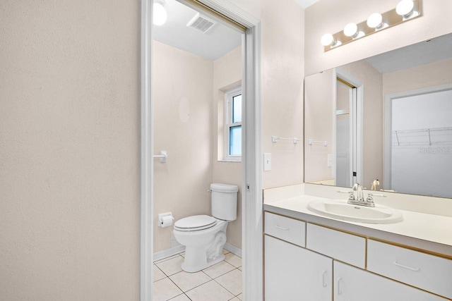 bathroom with vanity, tile patterned flooring, and toilet