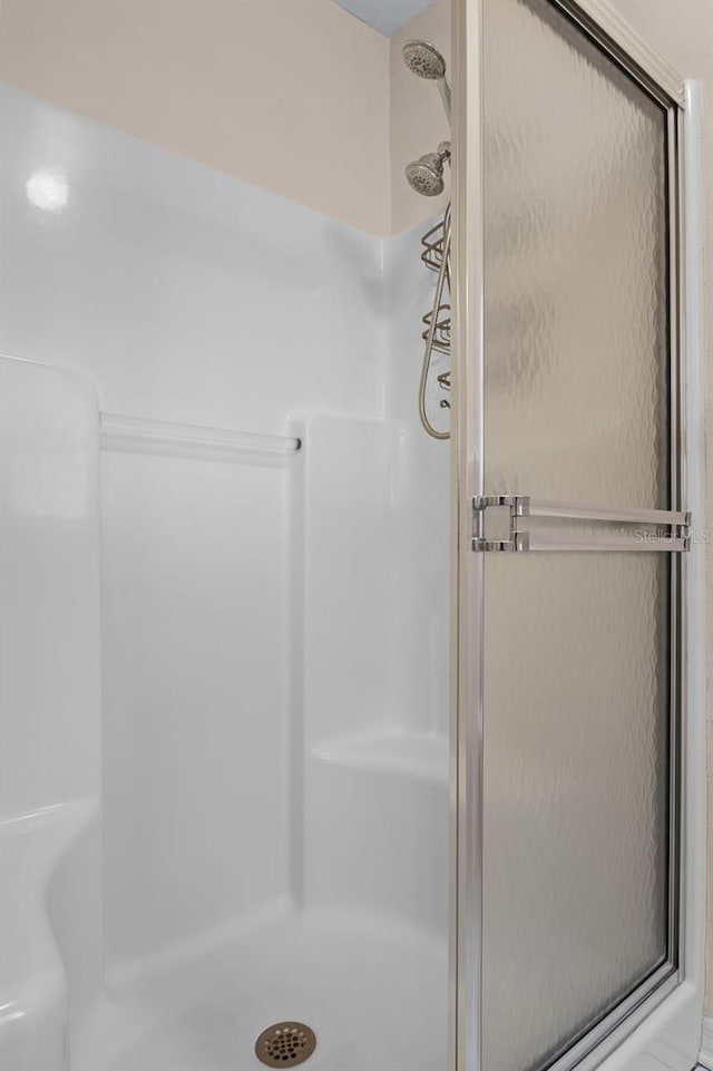 bathroom with a shower with door