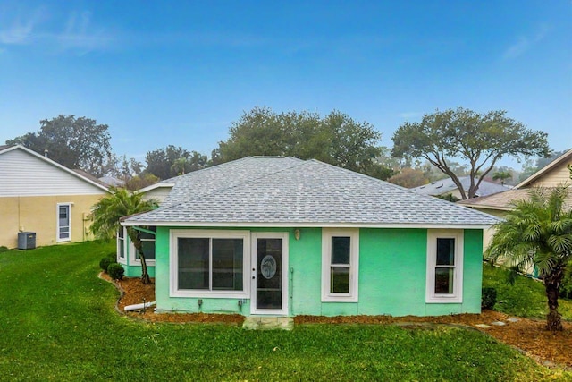 view of front of house featuring central AC and a front lawn