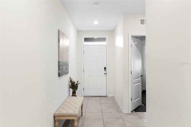 doorway with light tile patterned floors