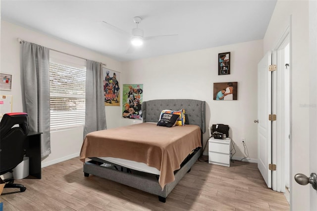 bedroom with ceiling fan and light wood-type flooring