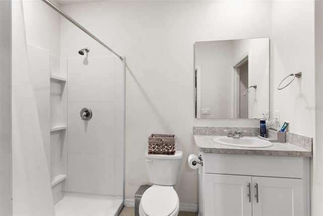 bathroom featuring walk in shower, vanity, and toilet