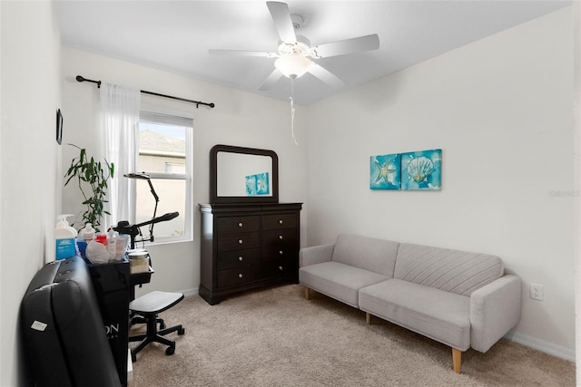 carpeted office space with ceiling fan