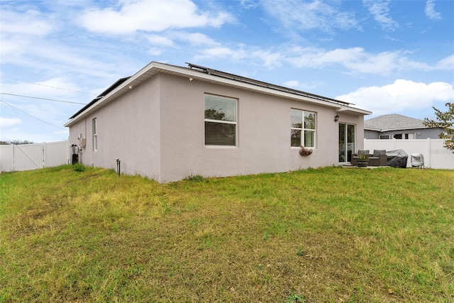 rear view of property with an outdoor hangout area and a lawn