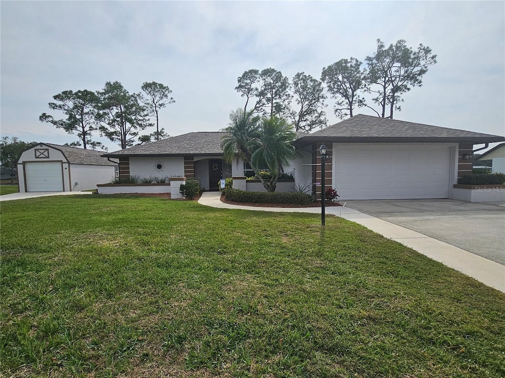 ranch-style home with a front lawn and a garage