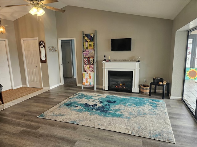 living room featuring ceiling fan, wood-type flooring, and lofted ceiling