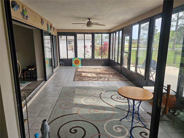 sunroom featuring ceiling fan