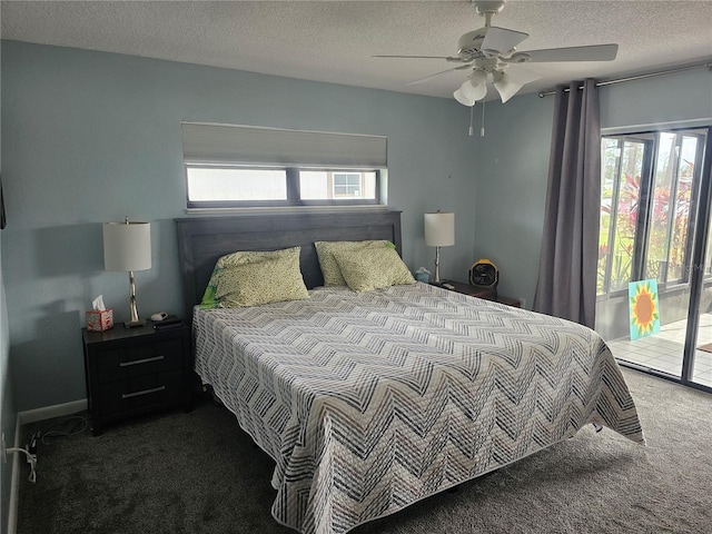 carpeted bedroom with access to outside, ceiling fan, multiple windows, and a textured ceiling