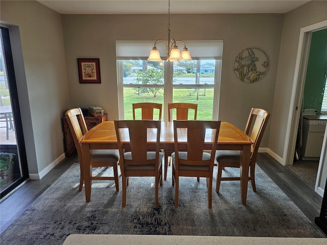 dining room featuring dark hardwood / wood-style flooring and a notable chandelier