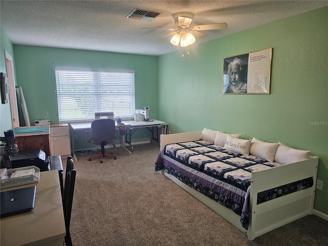 bedroom with a textured ceiling, ceiling fan, and carpet