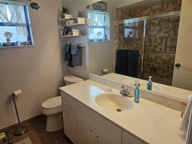 bathroom featuring an enclosed shower, vanity, tile patterned flooring, and toilet