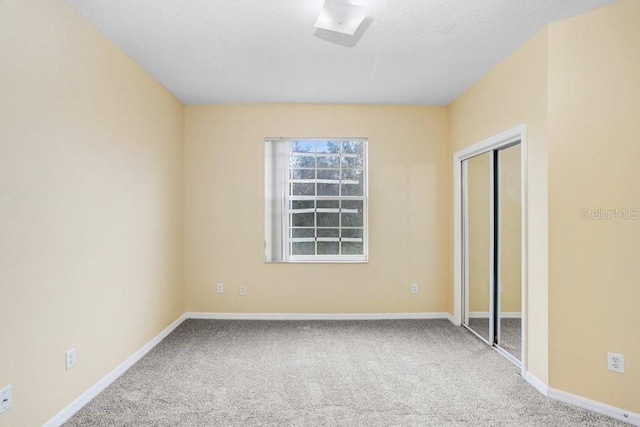 unfurnished bedroom with carpet floors and a closet