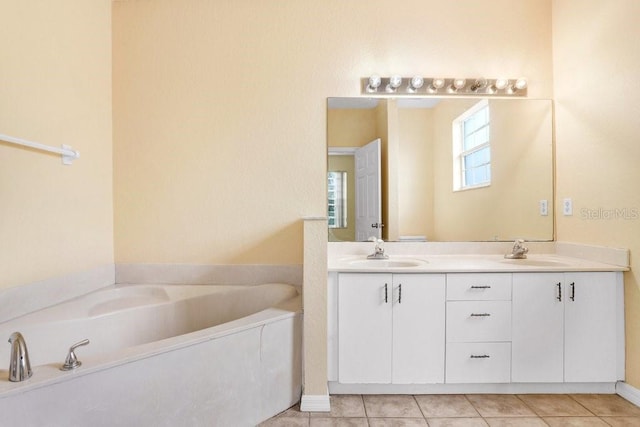 bathroom featuring a tub, tile patterned floors, and vanity