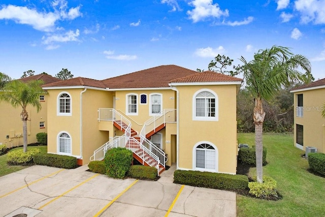 mediterranean / spanish-style home featuring a front yard