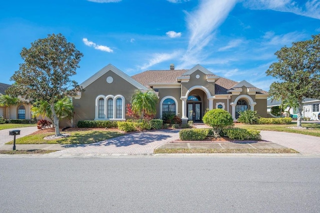 mediterranean / spanish house featuring french doors