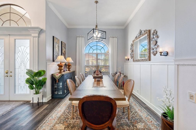 dining room with ornamental molding, dark hardwood / wood-style floors, a chandelier, and french doors