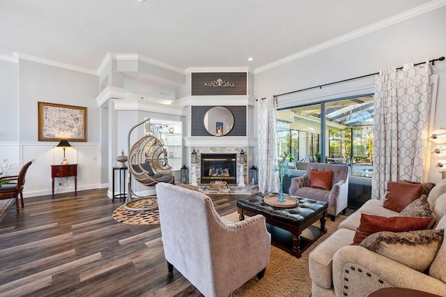 living room with ornamental molding, a fireplace, and dark hardwood / wood-style flooring