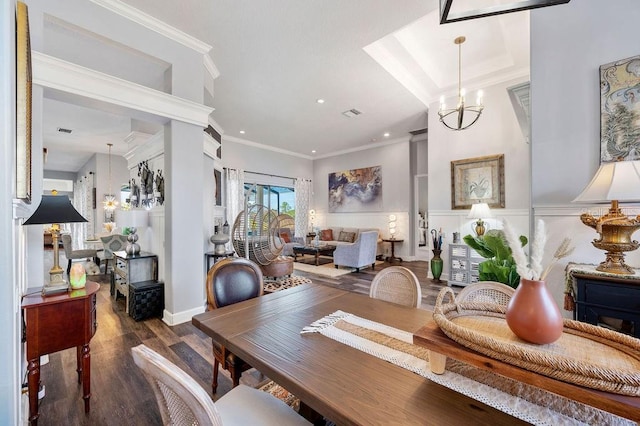 dining area with dark wood-type flooring, ornamental molding, and a notable chandelier