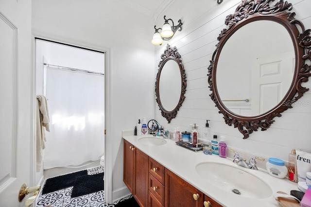 bathroom featuring tile patterned flooring, vanity, crown molding, and toilet